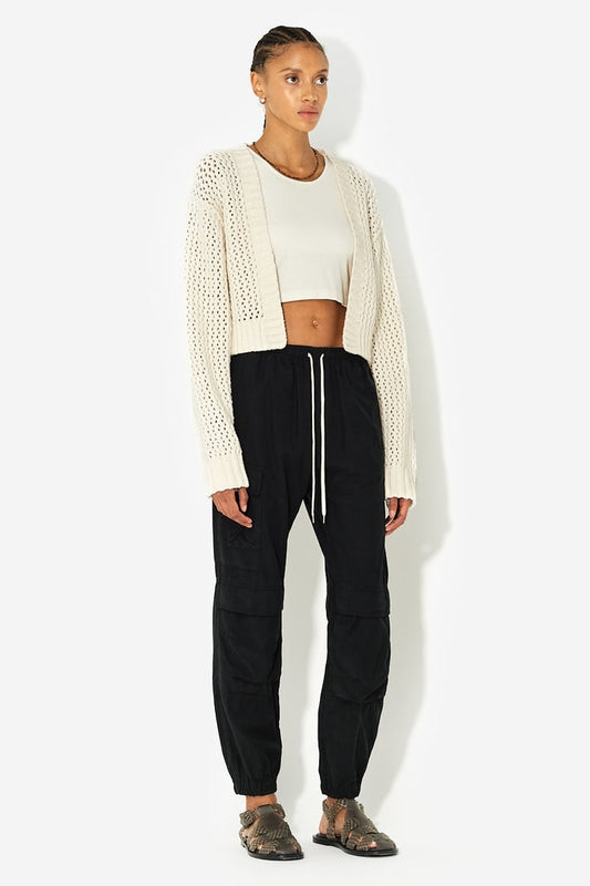 Long sleeve, cropped open knit cardigan with aysmmetrical hem. No front closure. Intricate ridge open network stitch, knit from Italian boucle yarn.  Cotton 82% + Nylon 18%  Fits true to size, take your normal size. Model is 5'9" and wears a size 1 / Small.  Dry Clean Only.